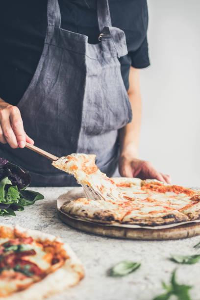 istock Hot pizza and slice with melting cheese 1373190189