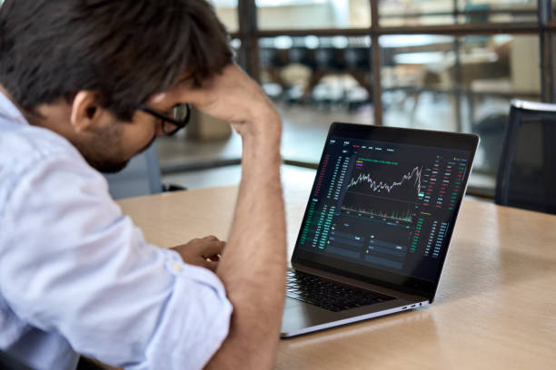 istock Stressed business man analyzing trading stock market trading fall down. 1373190654