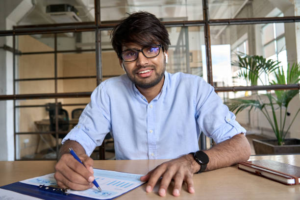 istock Young Indian financial advisor talking to web camera having virtual meeting. 1373190662