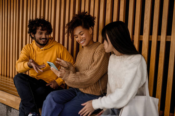istock Group of young people sitting close and talking 1373190746