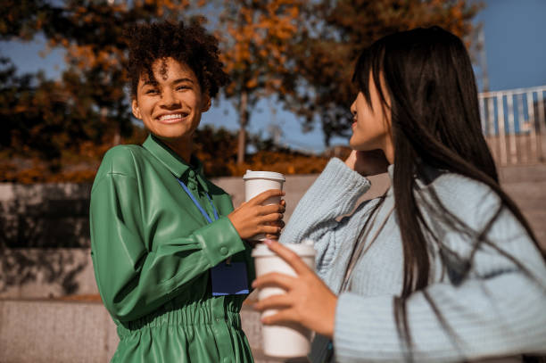 istock Two girls having coffee outside and talking 1373190803