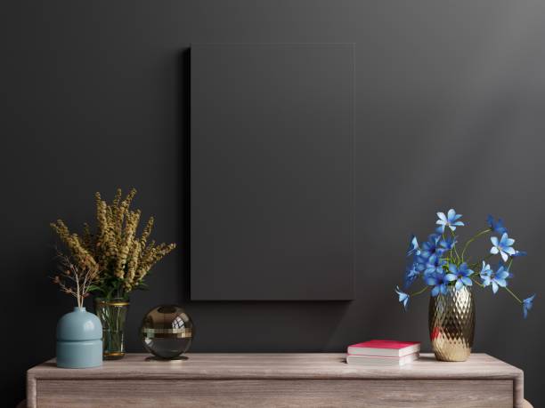 istock Mockup dark frame on cabinet in living room interior on empty black wall background. 1373204266