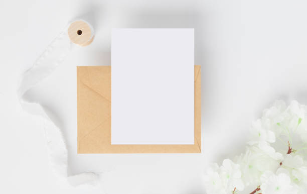 istock Blank greeting card invitation Mockup on Brown envelope with Dried bunny tails grass on white background, Minimal table workplace composition, flat lay, mockup 1373208396