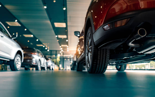 Rearview of parked cars Rearview of parked cars Car dealership office. New car parked in modern showroom. Automobile leasing and insurance concept. automobile industry stock pictures, royalty-free photos & images