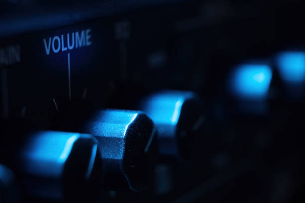 Volume control knob of a black amplifier on audio mixing console volume in a stereo