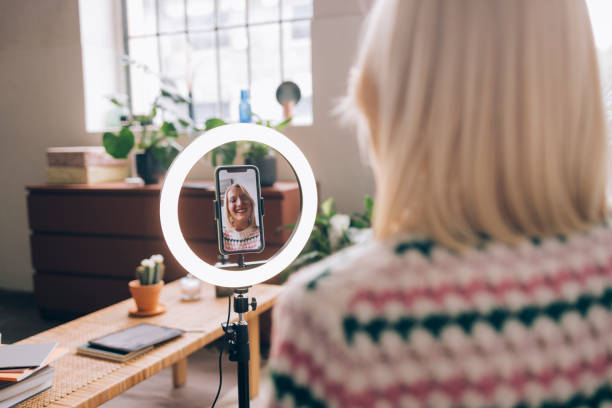 istock Anonymous Woman Talking to a Friend on a Video Call, Using a Video-Calling Smartphone Stand with Ring Light 1373215528