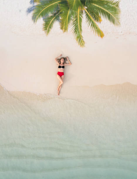 istock Drone view of beautiful woman under palm tree 1373216323