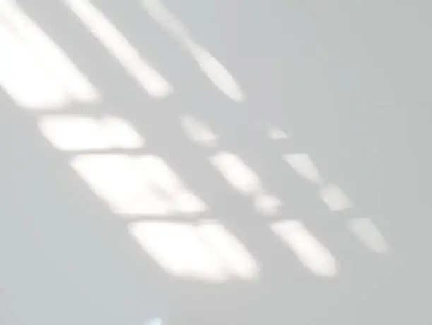 Photo of Window shadow drop on white wall background