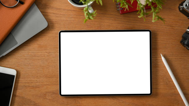 istock Top view, Digital tablet mockup on wooden table background 1373216712
