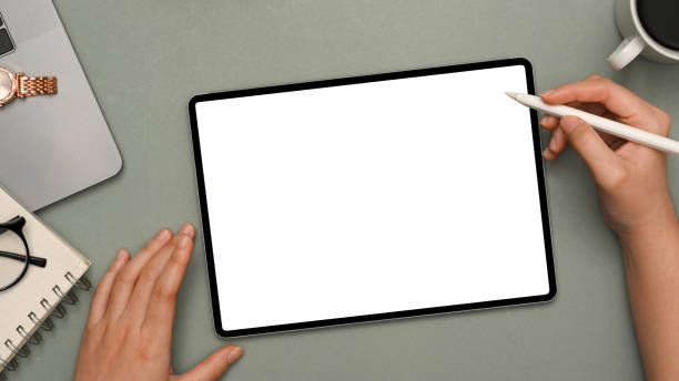 istock Female hand using stylus pen drawing on digital tablet 1373216720