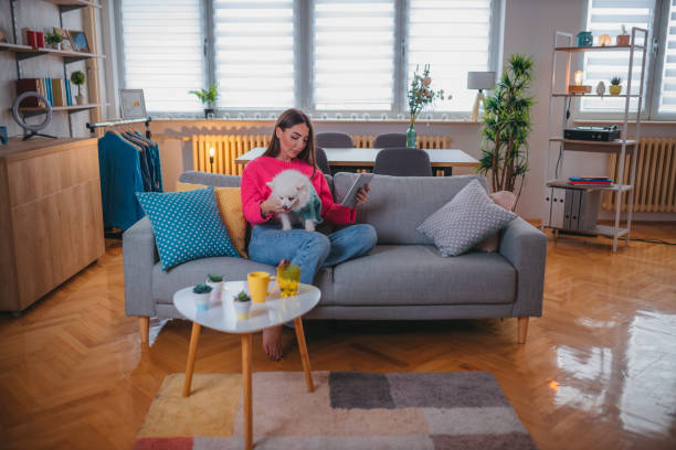 istock Attractive young woman holding a tablet at home 1373219312