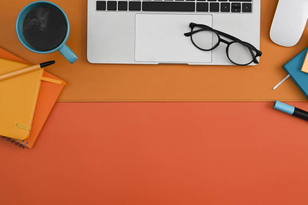 istock Laptop computer, glasses, coffee cup and notebook on colorful background. Top view. 1373224156