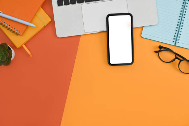 istock Mockup mobile phone, laptop computer, notebook and potted plant on colorful background. 1373224157