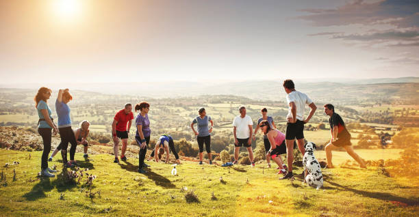 Shot of a group of people going for a run in nature The runner's club is ready for action fitness boot camp stock pictures, royalty-free photos & images