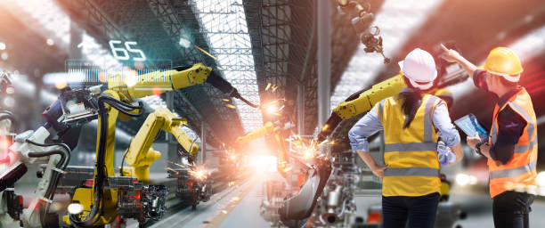 istock Professional team industrial engineers check, maintenance and control welding robotics automatic arms machine in factory automotive industry with monitoring system software. Industry 4.0 1373224975