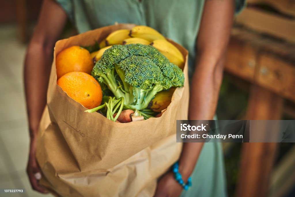 Shot of a young woman shopping for fresh produce at a farmer’s market They've got the best organic produce here Supermarket Stock Photo