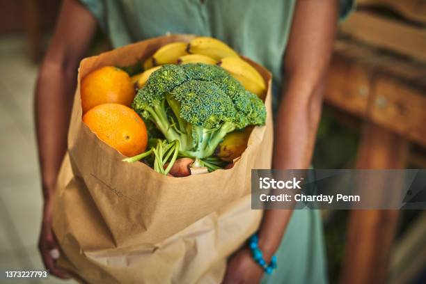 Shot Of A Young Woman Shopping For Fresh Produce At A Farmers Market Stock Photo - Download Image Now
