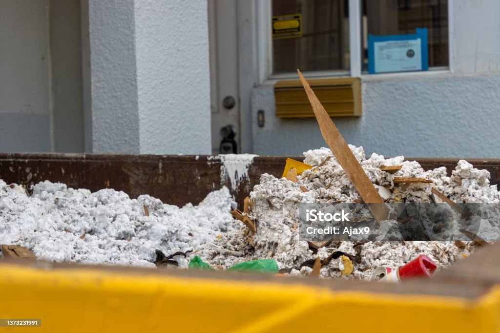 Insulation construction debris Debris in a dumpster from insulation work on a house. Insulation Stock Photo