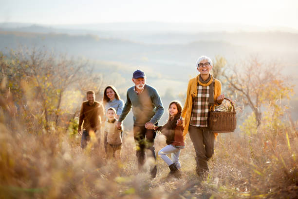 istock Happy multi-generation family going on a picnic in autumn day. 1373233907