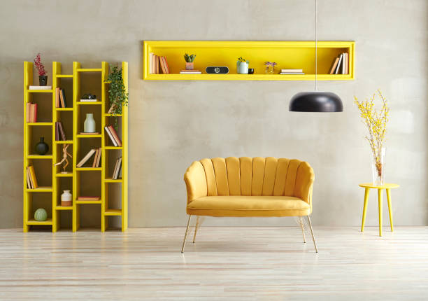 istock Grey concrete wall background with yellow bookshelf, sofa and niche with lamp. 1373233936
