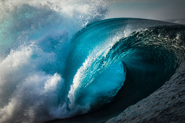 istock Full frame powerful teal blue wave breaking in open ocean on a bright sunny afternoon 1373234497