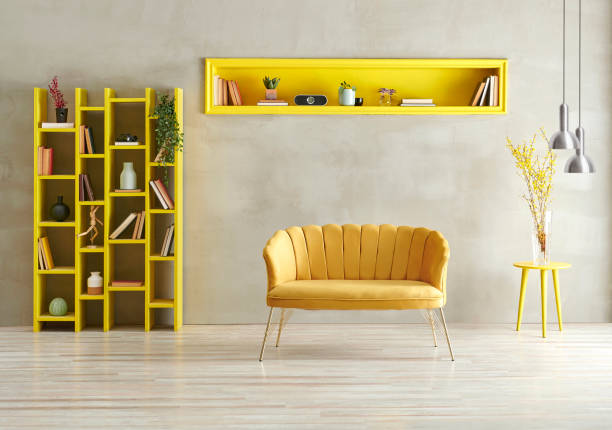 istock Grey concrete wall background with yellow bookshelf, sofa and niche with lamp. 1373234504