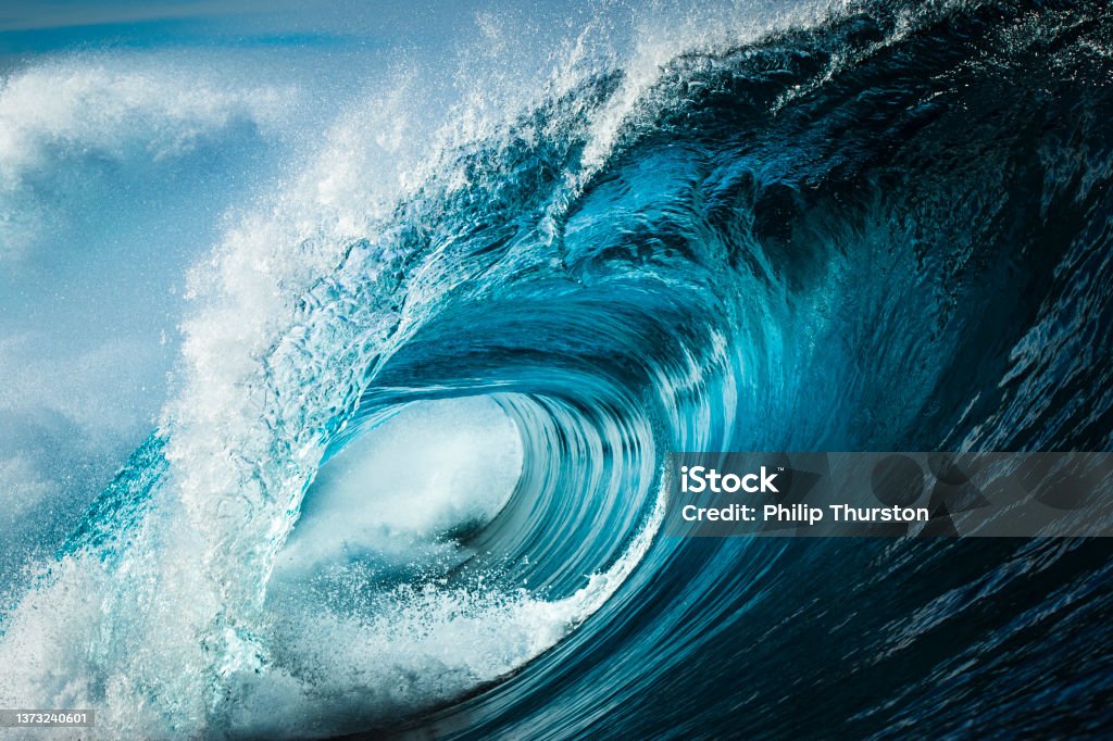 Close up detail of powerful teal blue wave breaking in open ocean on a bright sunny afternoon Wave - Water Stock Photo