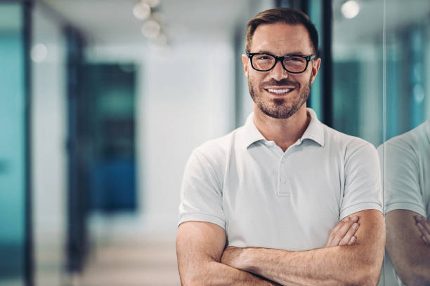 Smiling mid adult man in polo shirt stock photo