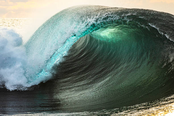 istock Morning sun shining through a round breaking ocean wave 1373241369