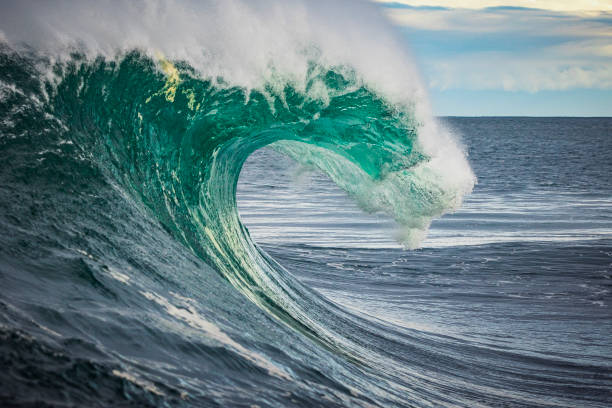 istock Powerful teal blue ocean forming into a breaking wave at dusk. 1373241999