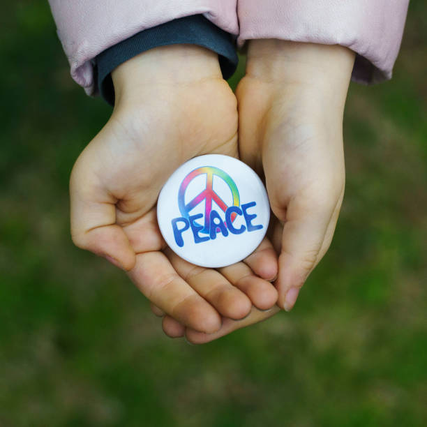 istock Little girl holding a peace rosette in hands, High angle view 1373242737