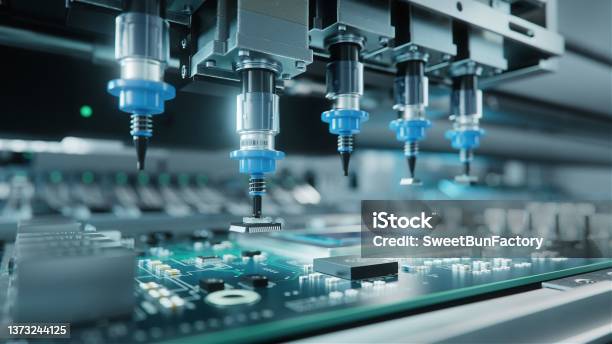 Automatic Pick And Place Machine Quickly Installs Components On Generic Circuit Board Electronics And Circuit Board Manufacturing Bright Environment Stock Photo - Download Image Now