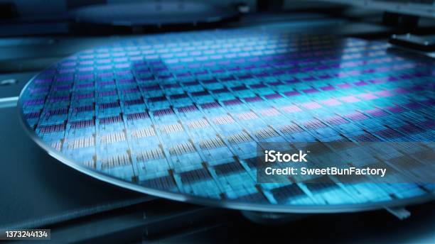 Macro Shot Of Silicon Wafer During Production At Advanced Semiconductor Foundry That Produces Microchips Stock Photo - Download Image Now