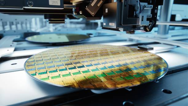 istock Close-up Shot of Silicon Wafer in Bright light at Advanced Semiconductor Foundry, that produces Computer Chips. 1373244151