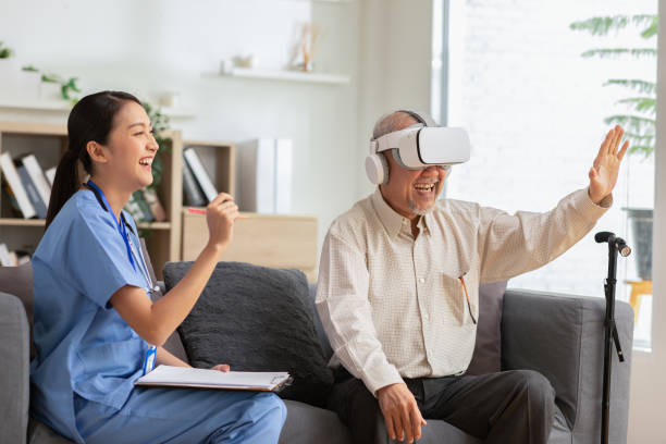 istock Asian Female doctor give advice elderly patient using VR or Virtual Reality glasses headset pointing objects or touching tracking health.Happy senior man having fun with goggle using VR enjoy at home 1373245522