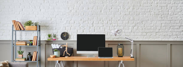 istock Modern working desk and wooden table design, computer and laptop style, home accessory, lamp and chair decor. White brick and brown classic wall background. 1373246023