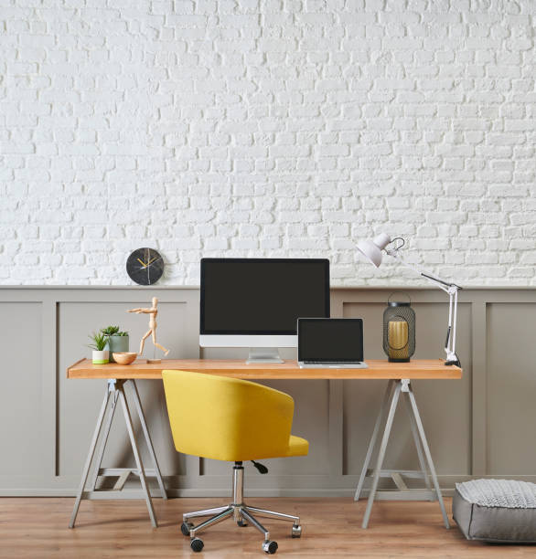 istock Modern working desk and wooden table design, computer and laptop style, home accessory, lamp and chair decor. White brick and brown classic wall background. 1373246067