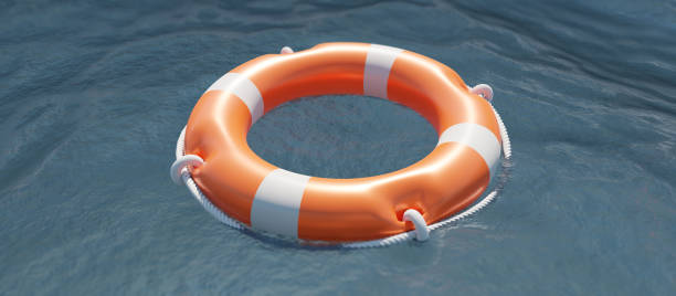 istock Lifebuoy on ocean water surface. Life preserver float ring, rescue life. Overhead view. 3d render 1373249389