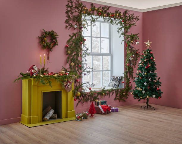 istock Christmas tree and yellow fireplace in front of the decorative windows, interior room, pine branch decoration, gift box and furniture chair and sofa design. 1373249532