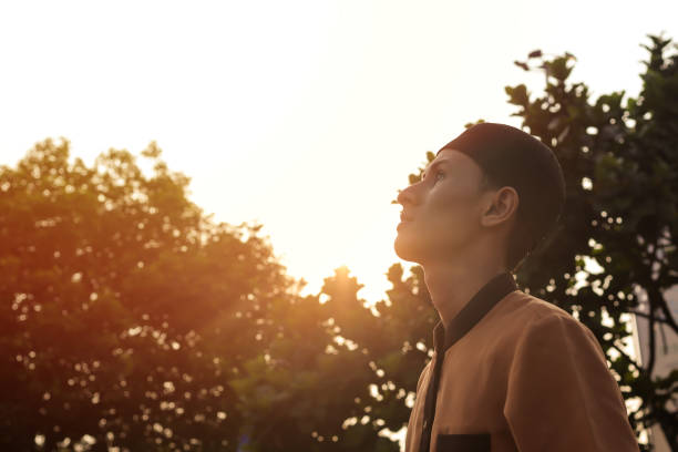 istock religious middle eastern man looking up against the sunrise background 1373249877