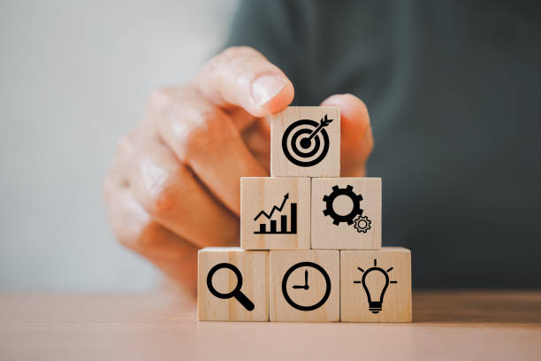 istock people's hand arranging wood block, pyramid shape, with business icon for strategy, action plan, growth business ,success process concept 1373250607