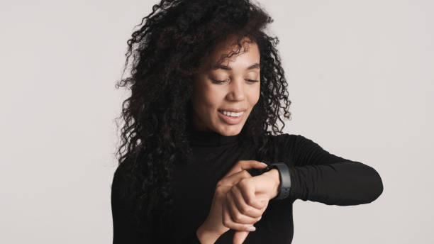 istock Young Afro woman looking happy answering on messages using smart 1373250757