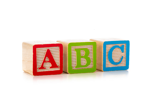 Front view of a group of wooden block shapes arranged side by side with A B C letters isolated on white background