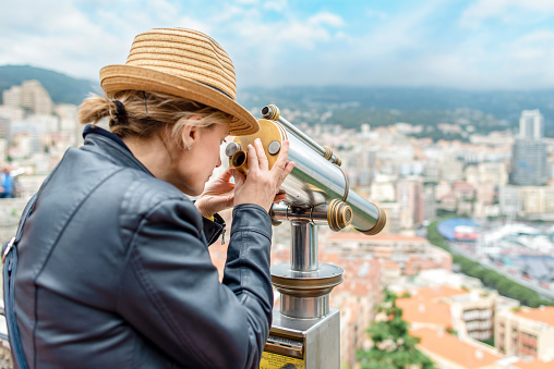 Tourist looking through telescope in Monaco