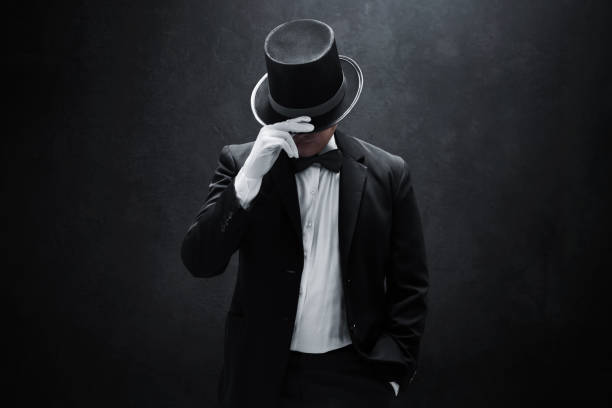 istock Mysterious man in black suit on dark background 1373255528