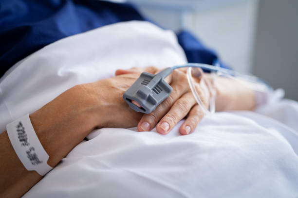 istock Patient hands with IV drip in hospital 1373258333