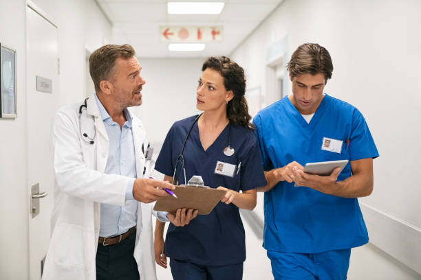 istock Doctor and nurses discussing patient case at hospital 1373258828