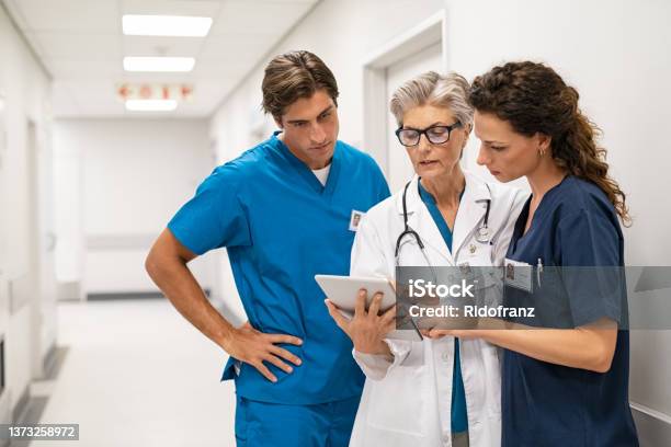 Doctor And Nurse Discussing Patient Case At Hospital Stock Photo - Download Image Now