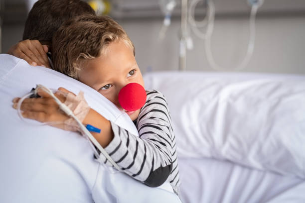 Grateful child hugging doctor in hospital