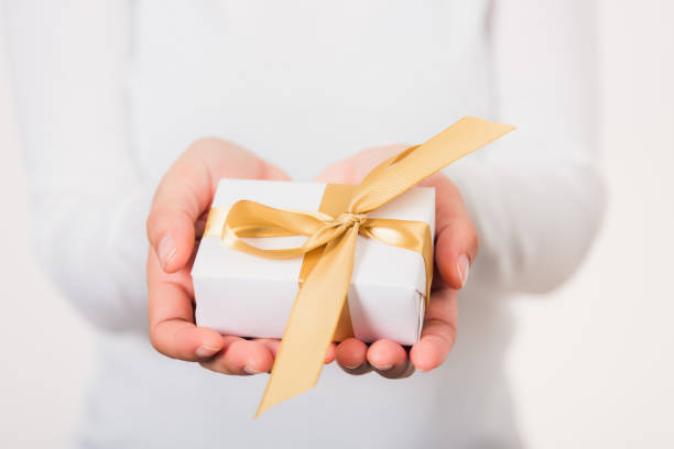istock Woman beauty hands holding small gift package box present 1373260166